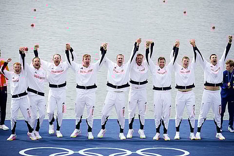 Men's eight rowing final: Britain team pose after winning gold